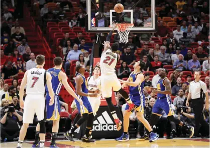  ??  ?? MIAMI: Hassan Whiteside #21 of the Miami Heat drives to the basket during a game against the Golden State Warriors at American Airlines Arena on Monday in Miami, Florida. — AFP