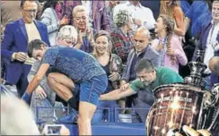  ?? AFP ?? Crowned champion, he climbs up to his box in the stands where wife Jelena led the cheering group.