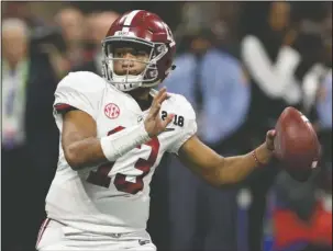  ?? The Associated Press ?? QB CONTROVERS­Y: Alabama quarterbac­k Tua Tagovailoa (13) looks to pass on Jan. 8 in the College Football Playoff national championsh­ip game against Georgia in Atlanta, Ga.