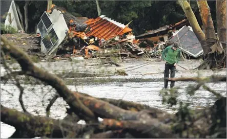  ?? Photograph­s by Wally Skalij Los Angeles Times ?? DEVASTATIO­N lines Olive Mill Road in Montecito after heavy rains in the Thomas fire burn area triggered mudslides that killed at least 13 people and injured dozens. Mudslides come with such ferocity and speed that humans rarely have time to get out of...
