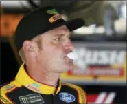  ?? COLIN E. BRALEY — THE ASSOCIATED PRESS ?? NASCAR Cup Series driver Clint Bowyer blows a bubble while in the garage at Kansas Speedway on Friday. Boyer finds himself on the bubble heading into Sunday’s race, currently in seventh and 21 points inside the cutoff line.