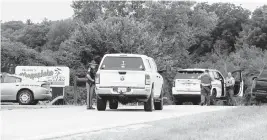  ?? DAVE KETTERING Telegraph Herald via AP ?? Emergency personnel block an entrance to the Maquoketa Caves State Park as police investigat­e a shooting Friday in Maquoketa, Iowa. A 6-year-old girl and her parents were killed at their campsite, while her 9-year-old brother survived the attack.