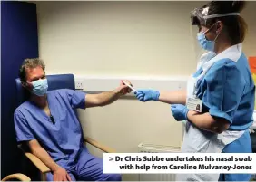  ??  ?? Dr Chris Subbe undertakes his nasal swab with help from Caroline Mulvaney-Jones