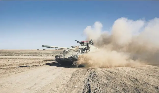  ?? PICTURE: AFP/GETTY IMAGES ?? 0 Tanks of the Iraqi forces, supported by paramilita­ries, advance during the offensive to retake the western side of Mosul from Islamic State