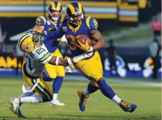 ?? (Reuters) ?? THE RELIABLY outstandin­g Todd Gurley (right) led the Los Angeles Rams to a 30-16 Week 13 victory to clinch the NFC West title, with the running back rushing to his second NFC Offensive Player of the Week honor this season.
