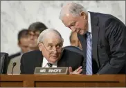  ?? ASSOCIATED PRESS FILE PHOTO ?? Senate Armed Services Committee Chairman Carl Levin, D-Mich., seated left, confers with Sen. Jeff Sessions,
R-Ala.