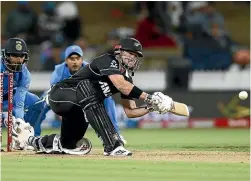  ?? GETTY IMAGES ?? Henry Nicholls hits out during his half-century for New Zealand in the opening ODI, an innings that ended with his run out, right.