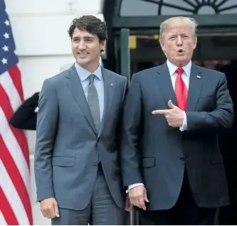  ?? SEAN KILPATRICK/THE CANADIAN PRESS ?? U.S. President Donald Trump with Prime Minister Justin Trudeau as he welcomes him to the White House on Wednesday.