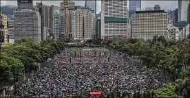  ?? FEI / THE NEW YORK TIMES LAM YIK ?? Demonstrat­ors gather at Victoria Park in Hong Kong on Sunday. After days of violence and warnings from the Chinese government, organizers estimated at least 1.7 million people had turned out to march through the dense city center in the pouring rain.