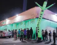  ?? JOHN LOCHER/ASSOCIATED PRESS ?? People line up at the NuLeaf marijuana dispensary in Las Vegas, Nev., on Saturday. Store owners have seen long lines outside their dispensari­es since sales began.