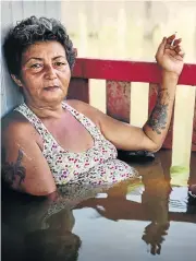  ?? /Supplied ?? Soaked through: Gideon Mendel’s photograph of a woman sitting in flood water in Rio Branco, Brazil, in March 2015.