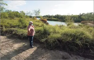  ?? Eric Gay / Associated Press ?? Pamela Rivas stands on her property that runs along the Rio Grande in Los Ebanos, Texas, on Nov. 20. The U.S. government has been trying to take Rivas' land for a border wall since before Joe Biden was vice president.