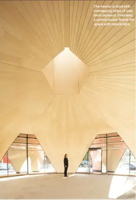  ??  ?? The interior is lined with overlappin­g strips of pale birch plywood. Overhead, a central oculus floods the space with natural light.