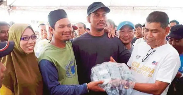  ?? FOTO: SYAFIQ AMBAK ?? SULAIMAN (dua dari kiri) menerima wang tunai RM105,000 selepas diumumkan juara Pertanding­an Memancing Penutup Tirai 2017 di Tasik Stadium Gong Badak, semalam.