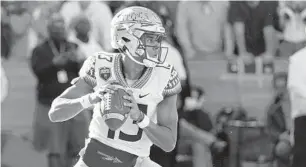  ?? JOHN RAOUX/AP ?? FSU quarterbac­k Jordan Travis, looking for a receiver against Florida in the regular-season finale, had his best season despite only starting eight games because of injuries.