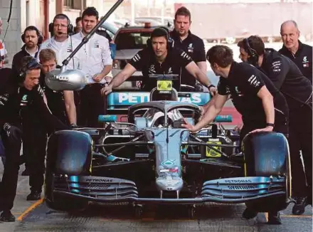  ?? REUTERS PIC ?? The car of Mercedes driver Valtteri Bottas is pushed down the pitlane during pre-season testing on Friday.