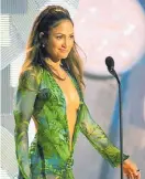  ??  ?? Jennifer Lopez in a Versace jungle dress of green silk chiffon at the 42nd Grammy Awards in Los Angeles on Feb. 23, 2000.