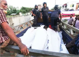  ??  ?? FIGHT AGAINST TERROR: Bangladesh policemen escort the bodies of suspected militants following an operation to storm a militant hideout in Narayangan­j on Saturday. (AFP)