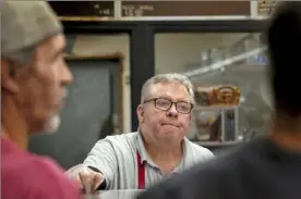  ?? ?? Russell Donatelli waits on customers during the lunch rush.