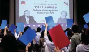  ?? REUTERSPIX ?? ... Students watch the televised US presidenti­al debate between Democratic presidenti­al nominee Hillary Clinton and Republican presidenti­al nominee Donald Trump at the US Embassy in Tokyo, Japan, yesterday.