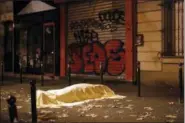  ?? JEROME DELAY — THE ASSOCIATED PRESS FILE ?? In this Friday file photo a victim under a blanket lays dead outside the Bataclan theater in Paris. Salah Abdeslam, the only surviving member of the 10-man Islamic State cell that attacked Paris in November 2015, is going on trial on Monday in Belgium....