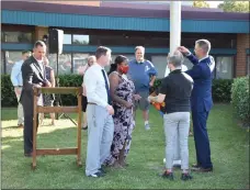  ?? PHOTO COURTESY OF NORTH PENN SCHOOL DISTRICT ?? North Penn school board members and district officials prepare to fly a rainbow Pride flag on a flagpole in front of the district’s Educationa­l Services Center on Thursday.