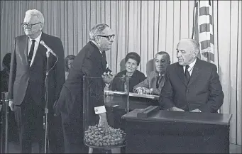  ??  ?? New York congressma­n Alexander Pirnie pulls out plastic lottery capsules in a live TV draw to decide which men will be drafted to the military and serve in Vietnam