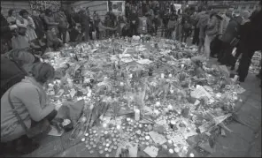  ?? AP/ALASTAIR GRANT ?? In the Place de la Bourse in central Brussels, people leave items Thursday in memory of the victims of this week’s terror attacks in Belgium.