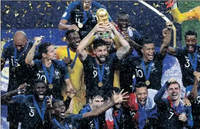  ?? AP PHOTO ?? France’s Olivier Giroud holds up the trophy as he celebrates with teammates after winning the World Cup yesterday in Moscow.