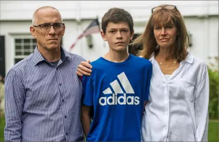  ?? Michael M. Santiago/Post-Gazette ?? From left, Roland, Louis and Christine Gargani in their front yard on May 1 in Upper St. Clair. Christine argues health insurers should send refunds to consumers who have been unable to schedule elective care at hospitals.