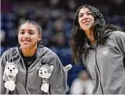  ?? Jessica Hill/Associated Press ?? UConn’s Azzi Fudd, left, and Jana El Alfy watch their team warm up before a game last season.