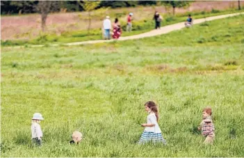  ?? AMR ALFIKY/THE NEW YORK TIMES ?? Children play last month at the U.S. National Arboretum in Washington, D.C. While kids under 12 can’t yet get COVID-19 vaccines, public health experts say being outdoors is a safer way for children to socialize.