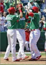  ?? JOHN RAOUX — THE ASSOCIATED PRESS ?? Philadelph­ia Phillies’ Howie Kendrick, right, celebrates his third inning home run against the Toronto Blue Jays with teammates including Cesar Hernandez (16) in a spring training baseball game, Friday, March 17, 2017, in Clearwater, Fla.
