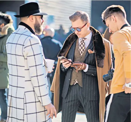  ??  ?? Following suit: visitors to the Pitti Uomo in Florence are dressed up to the sartorial nines, including Guillaume Bo, the French-canadian menswear consultant and blogger, right