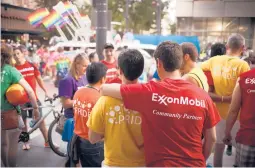  ?? MICHAEL STRAVATO/THE NEW YORK TIMES 2015 ?? Exxon Mobil says it won’t allow banners of outside organizati­ons on its flagpoles. Above, employees attend a pride parade in Houston.