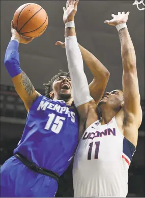  ?? Jessica Hill / Associated Press ?? David Nickelberr­y, left, shoots as Kwintin Williams defends Sunday in Storrs.