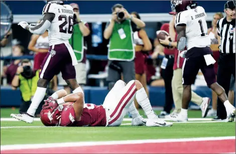  ?? NWA Democrat-Gazette/CHARLIE KAIJO ?? Arkansas Razorbacks tight end Cheyenne O’Grady (on ground) reacts Saturday after failing to convert on a fourth down with less than a minute on the clock during the fourth quarter at AT&T Stadium in Arlington, Texas.