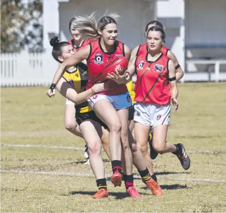  ?? Picture: Nev Madsen ?? ON THE CHARGE: Morgan Prior tries to get a handball away for South Toowoomba.