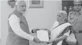  ?? — PTI ?? PM- elect and outgoing chief minister Narendra Modi submits his resignatio­n letter to Gujarat governor Kamla Beniwal in Gandhinaga­r on Wednesday.