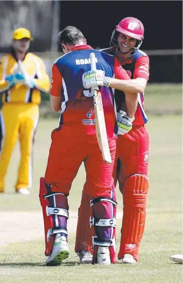  ?? Picture: STEWART MCLEAN ?? WELL DONE: Mulgrave’s Jake Roach is congratula­ted by teammate Neville Philp after reaching his ton in the Cricket Far North First Grade one-day match against Norths.