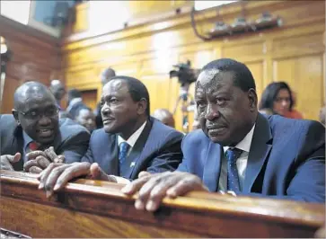  ?? Photograph­s by Dai Kurokawa EPA-EFE/REX/Shuttersto­ck ?? OPPOSITION presidenti­al candidate Raila Odinga, right, waits at the Supreme Court in Nairobi, Kenya, for the judgment on the election. “We have no choice but to nullify it,” Deputy Chief Justice Philomena Mwilu said.