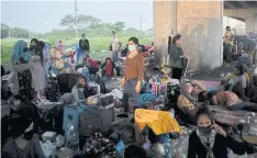  ??  ?? ABOVE
Stranded passengers, mostly overseas Filipino workers whose flights were cancelled due to the coronaviru­s outbreak, take shelter under an expressway outside Ninoy Aquino Internatio­nal Airport near Manila in June.