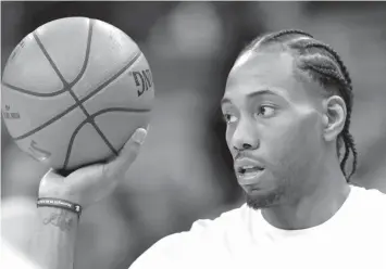  ?? ASSOCIATED PRESS FILE PHOTO ?? San Antonio Spurs forward Kawhi Leonard handles a ball before an NBA basketball game against the Phoenix Suns in San Antonio. A person familiar with the situation tells The Associated Press, that Leonard has told the Spurs that he would like to be...