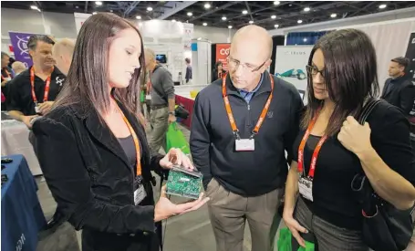  ?? WAYNE CUDDINGTON/OTTAWA CITIZEN ?? Tiffany Arcaris, VP of Global Sales at Xi3 Corporatio­n, explains the benefits of the Xi3 Modular Computer at GTEC 2013, at the Ottawa Convention Centre.