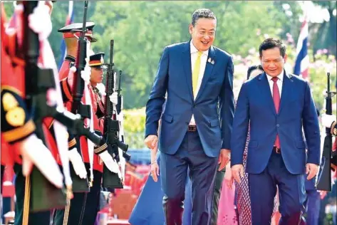  ?? SRETTHA VIA X ?? Prime Minister Hun Manet inspects a guard of honour with his Thai counterpar­t Srettha Thavisin in Bangkok on February 7.