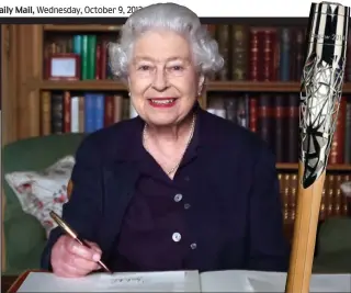  ??  ?? Secret: Her Majesty the Queen pens the message at Balmoral. Inset: The baton