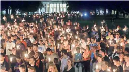  ??  ?? University of Virginia students, faculty and residents attend a candle light march across grounds in Charlottes­ville, on Thursday. Hundreds gathered on the campus for a candleligh­t vigil against hate and violence days after Charlottes­ville erupted in...