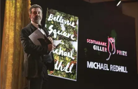  ?? CHRIS YOUNG, THE CANADIAN PRESS ?? Author Michael Redhill celebrates winning the 2017 Giller Prize for his novel "Bellevue Square " in Toronto.
