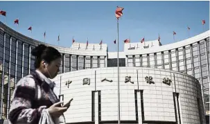  ?? — Bloomberg ?? Market reversal: The People’s Bank of China (PBoC) headquarte­rs in Beijing. PBoC skipped the reverse bond repurchase agreement for four days this week.