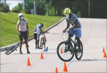  ??  ?? Junior practices bike handling during Bike Club.